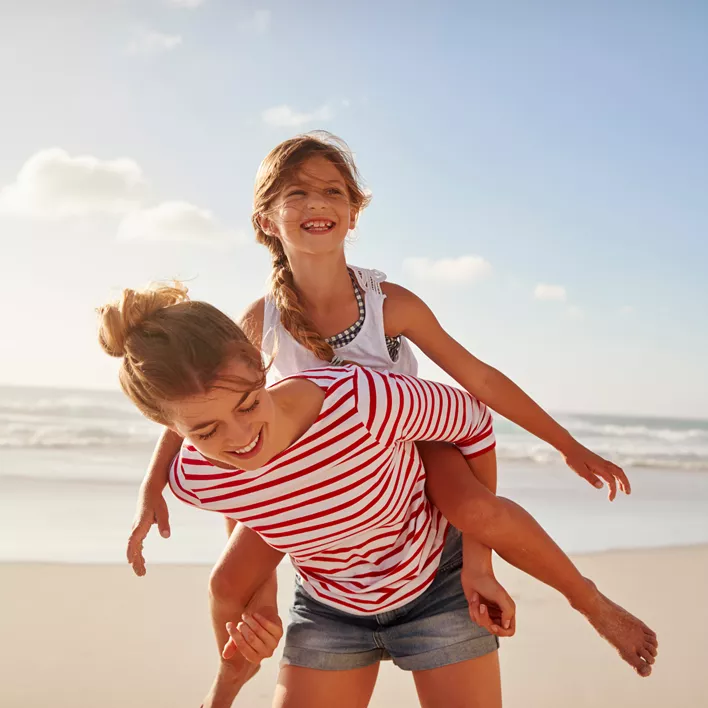 Kids playing on the beach and laughing 